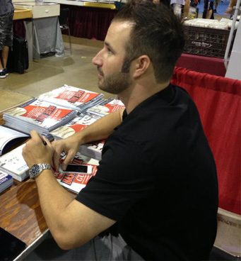 Brandon Grunbaum signing guides at a show